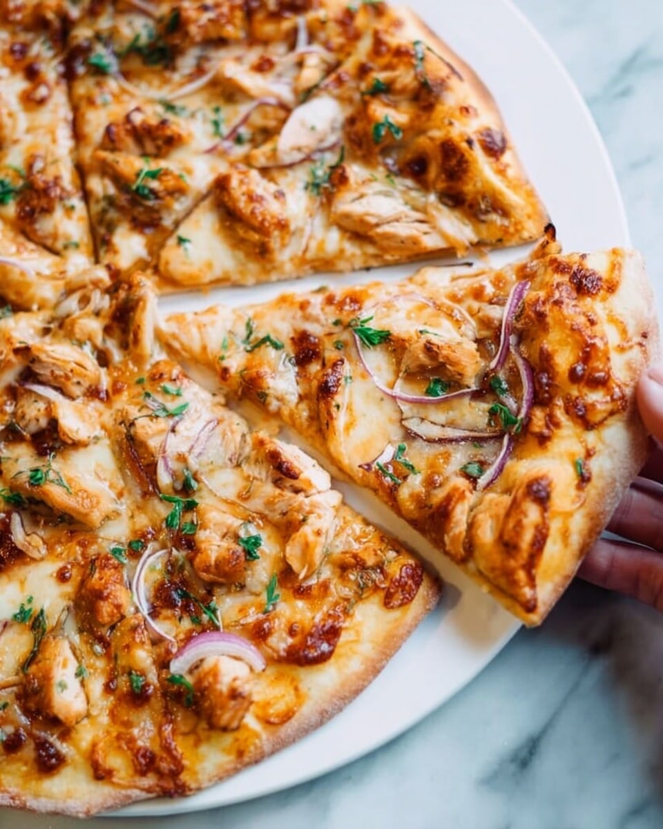 A slice of pizza is being held by a woman's hand above a pizza with multiple slices. The pizza has a thick golden brown crust with slightly charred spots. The layers include a base layer of melted cheese that is creamy white with browned patches, topped with pieces of cooked chicken that are light brown with reddish edges, scattered bits of red onion, and small green parsley leaves spread evenly on top. The background has a white marbled texture. photo taken with an iphone --ar 4:5 --v 7
