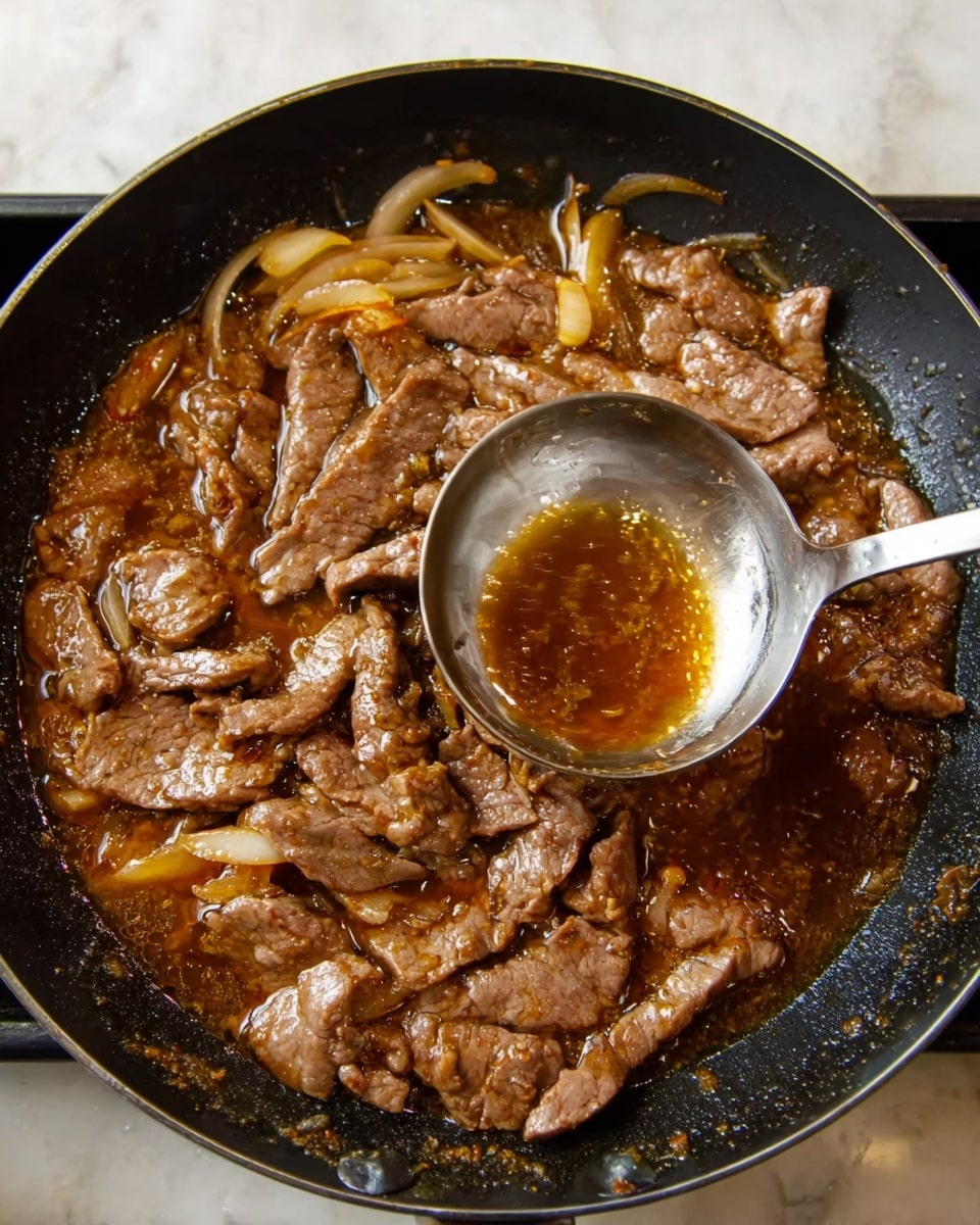 The image shows a dark skillet filled with thin slices of cooked meat in a rich brown sauce with some visible oil floating on top. Underneath the meat, there are light yellow onion slices partially submerged in the sauce. A shiny metal ladle is held above the skillet, with its bowl slightly dipped into the sauce, showing some liquid inside. The skillet rests on a white marbled surface. photo taken with an iphone --ar 4:5 --v 7