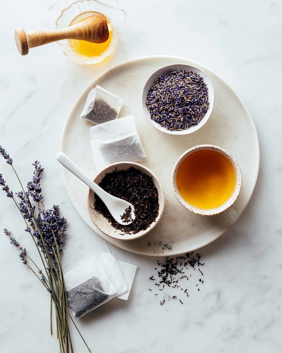 The image shows a flat white round plate holding three small bowls and two lavender sprigs. The top right bowl contains dried purple lavender flowers. Below it, the middle bowl is filled with golden honey with a smooth texture. Next to the honey bowl, on the lower right side, a bowl with black loose tea leaves has a white spoon resting inside with some tea leaves scattered nearby. On the left side of the plate, a white spoon with light brown liquid sits in front of two dark tea bags wrapped in white paper. A glass jug with a wooden handle is partly visible on the top left corner. The entire arrangement lies on a white marbled surface, photo taken with an iphone --ar 4:5 --v 7