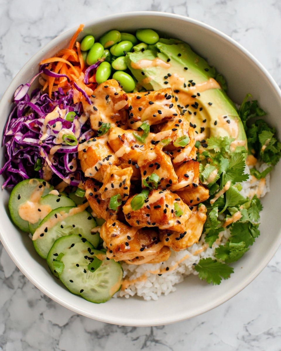 A white bowl filled with several layers: the bottom layer is white rice covering the whole bowl; on top, there are pieces of orange-browned chicken arranged in the center, drizzled with creamy light orange sauce and sprinkled with black sesame seeds; to the left side, there are thin purple cabbage shreds mixed with orange carrot strips, light green avocado slices, and bright green edamame beans; below these, there are round slices of fresh green cucumber; fresh cilantro leaves are scattered around the chicken and vegetables adding green touches; the bowl sits on a white marbled surface; photo taken with an iphone --ar 4:5 --v 7