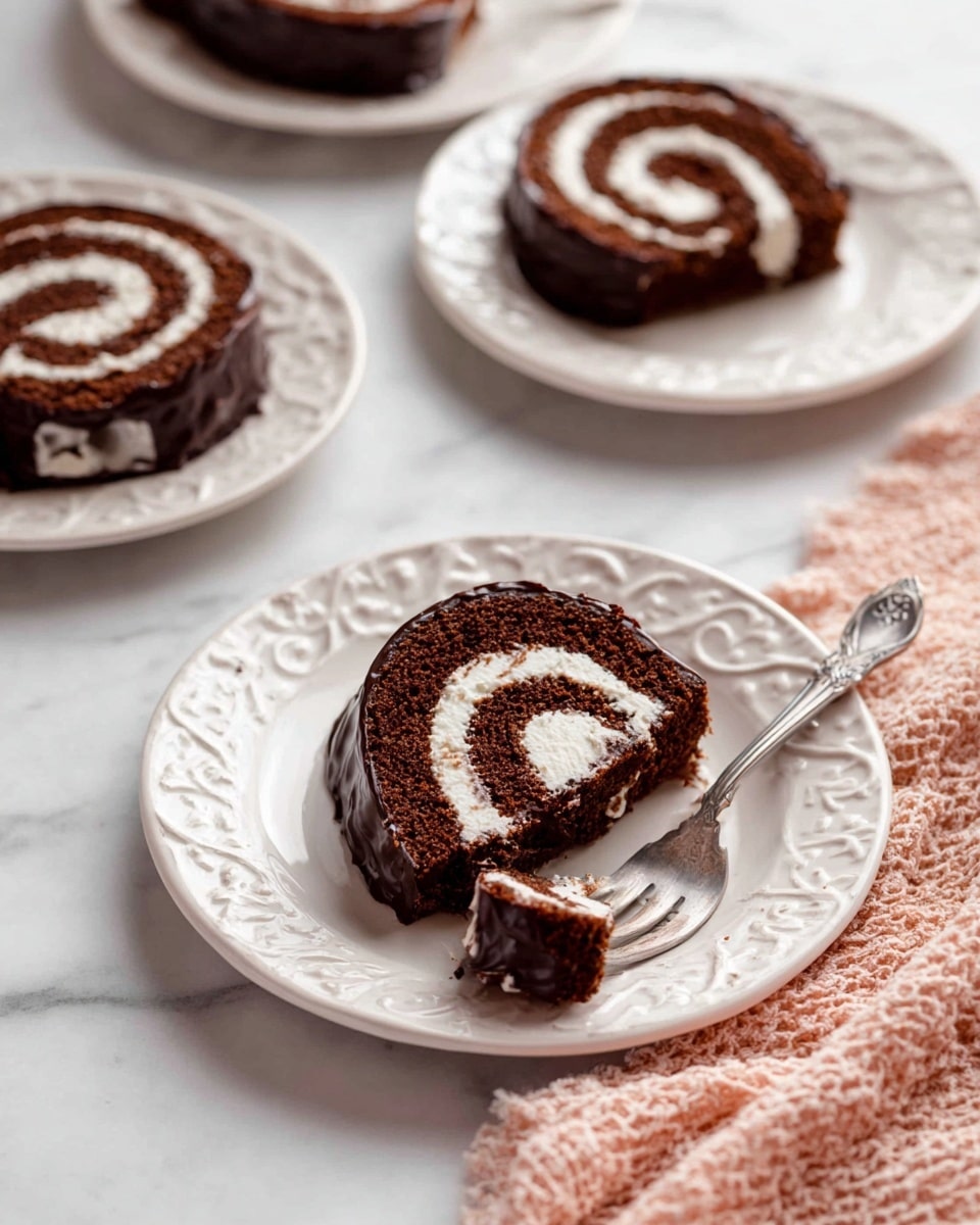 The image shows a chocolate roll cake sliced into spirals on white plates. Each slice has two main layers: a dark brown chocolate sponge rolled tightly with a light, creamy white filling spiraling through the center. The outside of the roll is covered in a shiny dark chocolate coating that wraps around the edges. One slice is on a plain white plate with a silver fork holding a small piece of cake near the edge. Three other slices are on white plates with intricate raised patterns around the edges, placed on a white marbled surface. A soft pink and white textured cloth is partially visible in the bottom right corner. Photo taken with an iphone --ar 4:5 --v 7