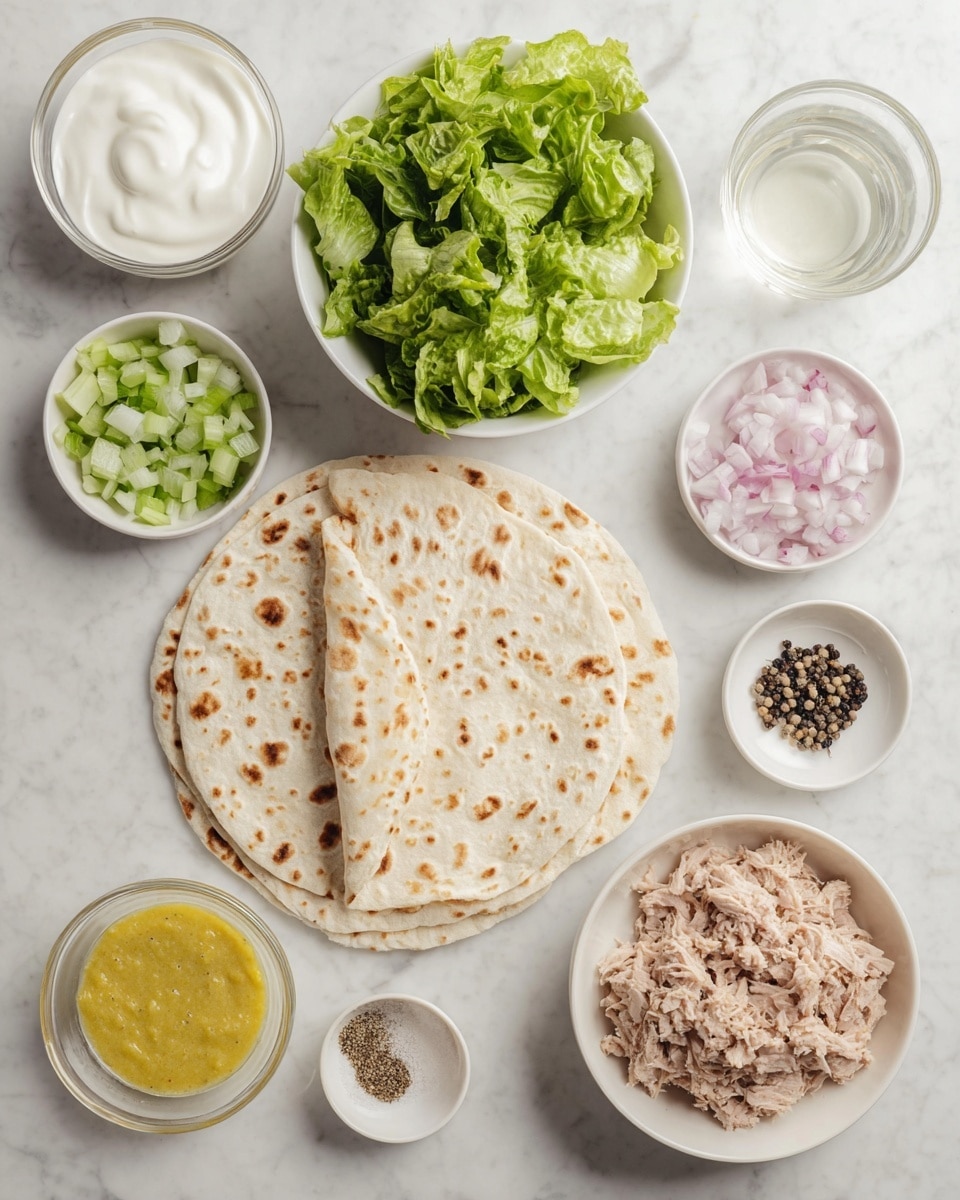 The image shows several white dishes arranged on a white marbled surface. In the center, there are two folded flatbreads with small brown seeds scattered throughout, giving a light toasted look. Above the flatbreads, a white bowl holds fresh green lettuce leaves, torn into medium pieces, showing their curly texture. At the bottom right, a white bowl contains shredded light brown tuna. To the left of the tuna, a small white plate holds finely chopped green celery and pinkish diced onion side by side. At the top left, a white bowl is filled with thick white creamy yogurt. Next to it, a small white bowl contains a clear liquid, likely vinegar or lemon juice. At the far right, a small white bowl holds coarse salt mixed with whole black peppercorns, and next to it, another small white bowl is filled with bright yellow mustard sauce. All elements have a fresh, clean look, arranged neatly. photo taken with an iphone --ar 4:5 --v 7