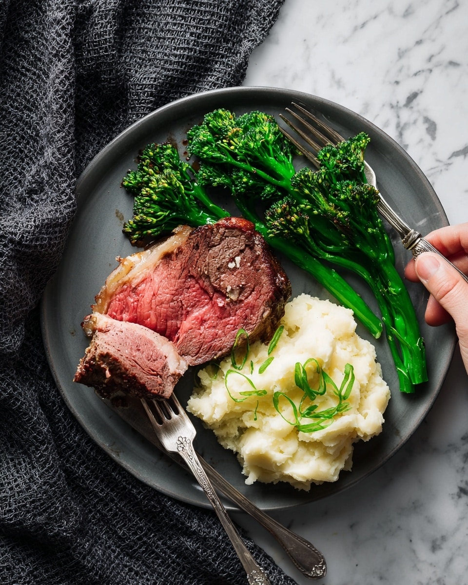 A white plate holds a meal with three main parts: a thick, medium-rare piece of steak with a pink center and a bit of browned fat around the edges on the upper right; a small pile of fluffy mashed potatoes, topped with thin green onion slices, placed just below the steak; and several bright green broccolini stalks with a slightly charred look on the bottom left. A fork and a knife rest on the plate, with a woman's hand holding the fork touching a piece of steak. The plate sits on a white marbled surface with a dark gray textured cloth nearby. Photo taken with an iphone --ar 4:5 --v 7