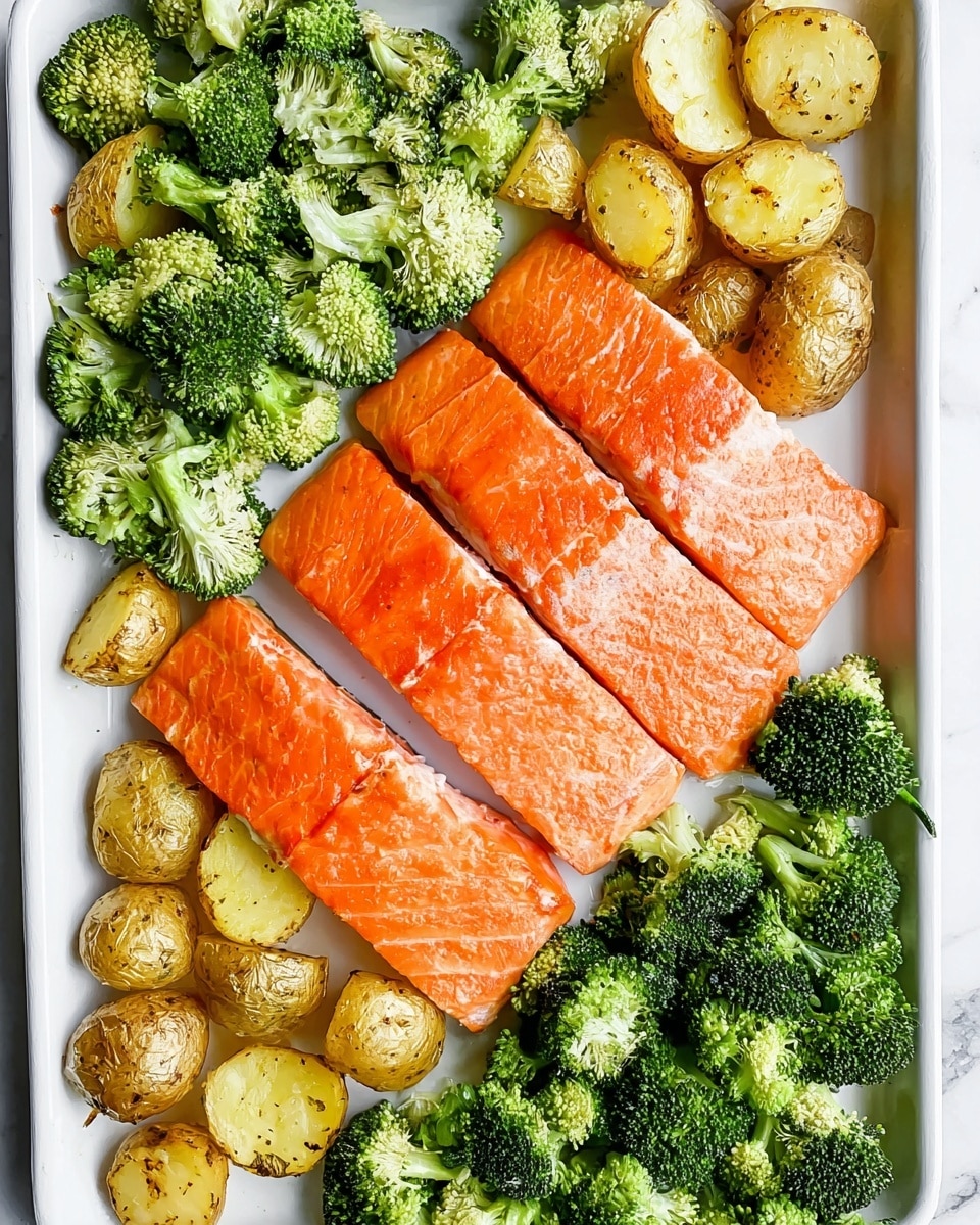 A white tray shows a simple meal with three bright orange salmon fillets lined up in the middle. On the left side of the fillets, there are small, light brown roasted potato pieces scattered tightly, showing a crispy texture. On the right side, fresh green broccoli pieces are spread out, filling the edge of the tray. The tray is set on a white marbled surface. photo taken with an iphone --ar 4:5 --v 7