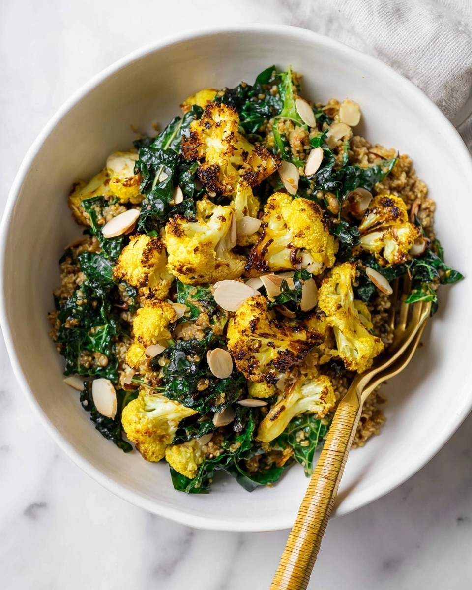 A white bowl filled with a colorful mix of roasted yellow cauliflower pieces at the top layer, showing a slight char and a textured surface. Beneath and mixed in are deep green, wilted kale leaves with a soft, leafy texture. Small toasted almond slices are scattered evenly on top, adding a light beige contrast. The dish also contains a layer of light brown grains or seeds that add a subtle texture throughout. The bowl sits on a white marbled surface, and a gold fork with a woven handle is placed in the bowl from the right side, partially submerged in the food. Photo taken with an iphone --ar 4:5 --v 7