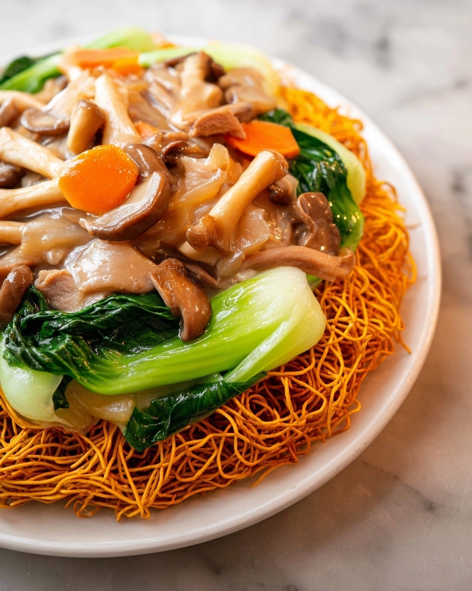 A white plate holds a dish with three main layers. The bottom layer is crispy orange noodles that form a nest-like base. On top of the noodles, there is a layer of green bok choy with thick white stems and dark green leaves. The top layer is a mix of light brown mushrooms, some long and thin, others rounded and clustered, along with light brown slices of cooked meat, and chunks of bright orange carrot, all covered in a shiny light sauce. The plate is on a white marbled surface. Photo taken with an iphone --ar 4:5 --v 7