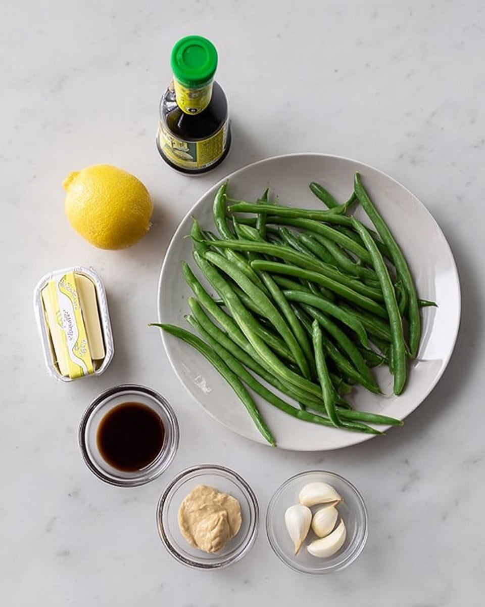 A white plate filled with fresh green beans is placed on a white marbled surface. Next to the plate are a small stick of butter in a wrapper, a whole yellow lemon, a small clear glass bowl with three peeled garlic cloves, a small clear glass bowl with a mustard-colored paste, and another small clear glass bowl containing a dark brown liquid. Behind these ingredients, there is a tall dark green bottle with a green cap and a yellow label. photo taken with an iphone --ar 4:5 --v 7