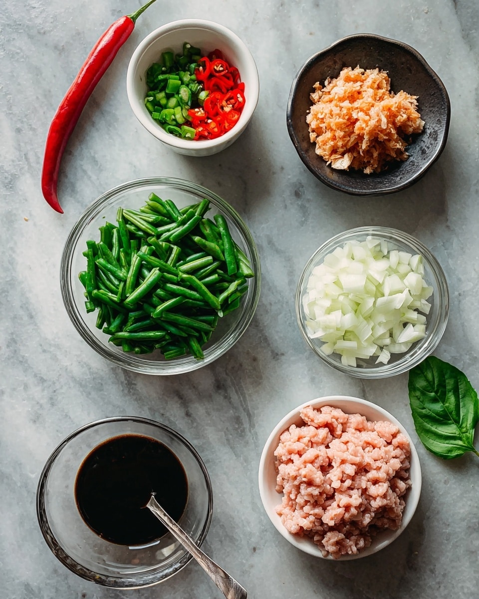 The image shows six bowls placed on a white marbled surface. At the top left, there is a small white bowl containing a whole red chili, a green chili, and chopped red and green chili pieces. To the top right, there is a black bowl filled with a pale orange minced ingredient that looks like chopped garlic and chili mix. In the center, a clear glass bowl holds medium-sized chopped green beans. To the right of it, another clear glass bowl contains chopped white onions. At the bottom left, a clear glass bowl filled with dark soy sauce has a spoon in it. Towards the bottom right, there is a small bowl with bright green fresh basil leaves. Lastly, at the bottom center, a white bowl holds raw ground meat that is pale pink in color. The bowls are neatly arranged and well-lit, giving a fresh and organized look. Photo taken with an iphone --ar 4:5 --v 7