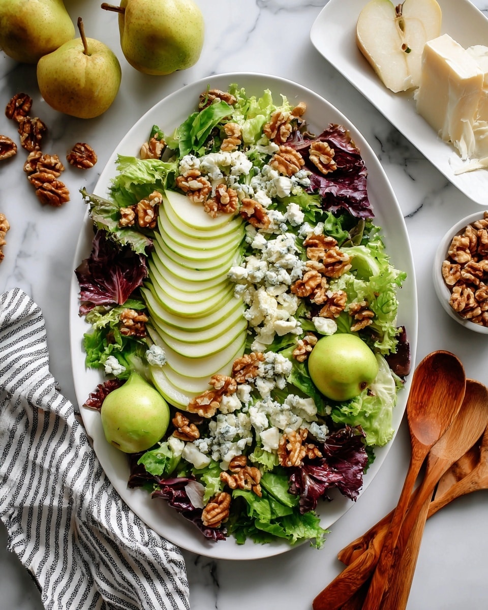 A large white oval plate holds a fresh salad with multiple layers: a base of mixed green and purple lettuce leaves with ruffled edges, thinly sliced green pears arranged in neat, curved rows on two sides, and whole green pears placed in the center and near the sides. Scattered on top are small clusters of golden-brown walnuts and crumbles of white cheese with blue veins, adding texture and color contrast. The plate rests on a white marbled surface, surrounded by whole pears, walnuts, and a white dish with more cheese visible at the top right. A wooden salad spoon set and a striped cloth napkin lie beside the plate, with a woman's hand reaching in from the right. photo taken with an iphone --ar 4:5 --v 7