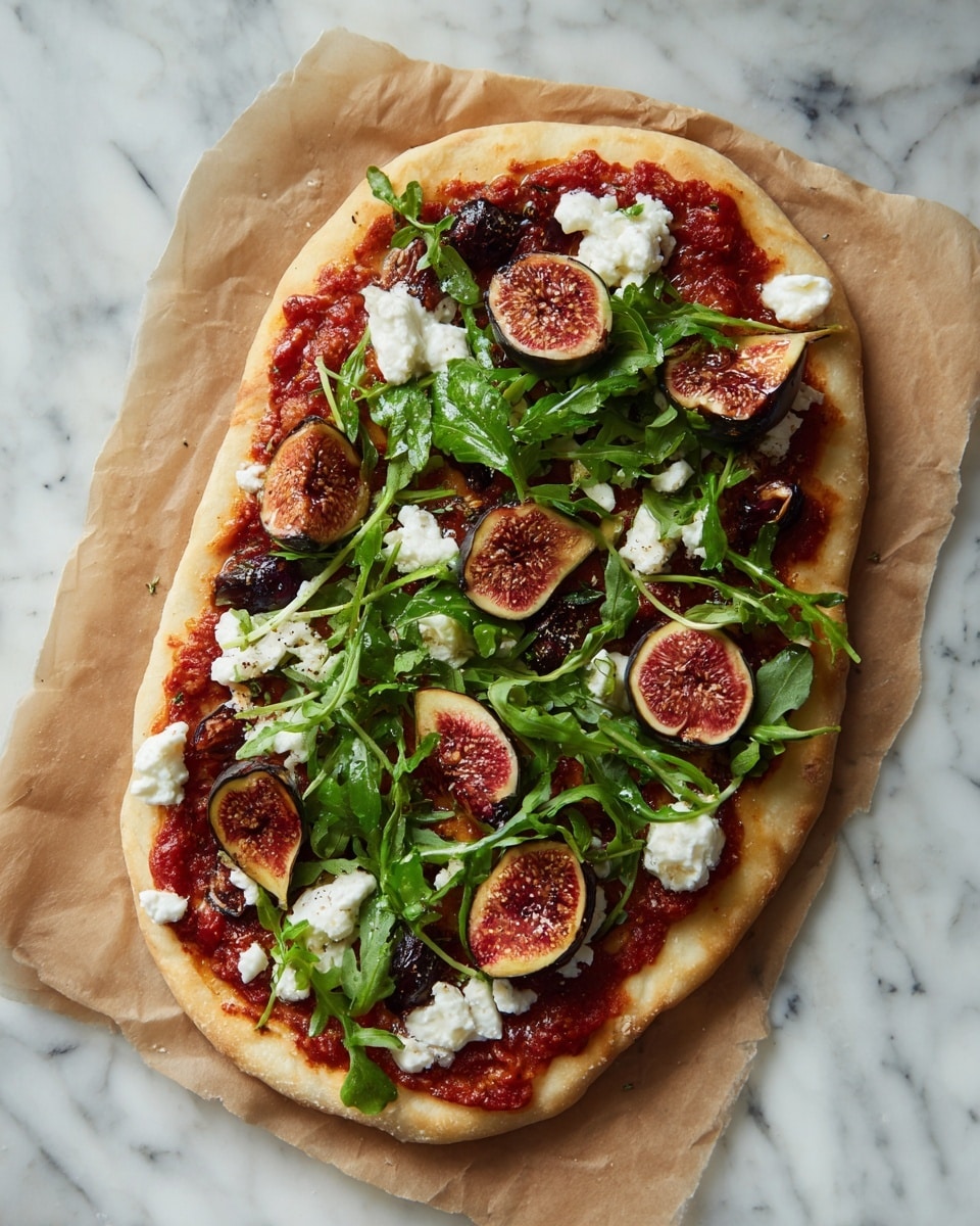 An oval flatbread pizza is shown on a piece of brown parchment paper over a white marbled surface. The pizza has a light golden crust with a layer of red tomato sauce spread unevenly. On top are scattered dark green arugula leaves, halved figs with purple skins and pinkish interiors, and small dollops of white soft cheese. The colors contrast well with the light crust, and the textures range from smooth sauce to leafy greens and crumbly cheese. Photo taken with an iphone --ar 4:5 --v 7