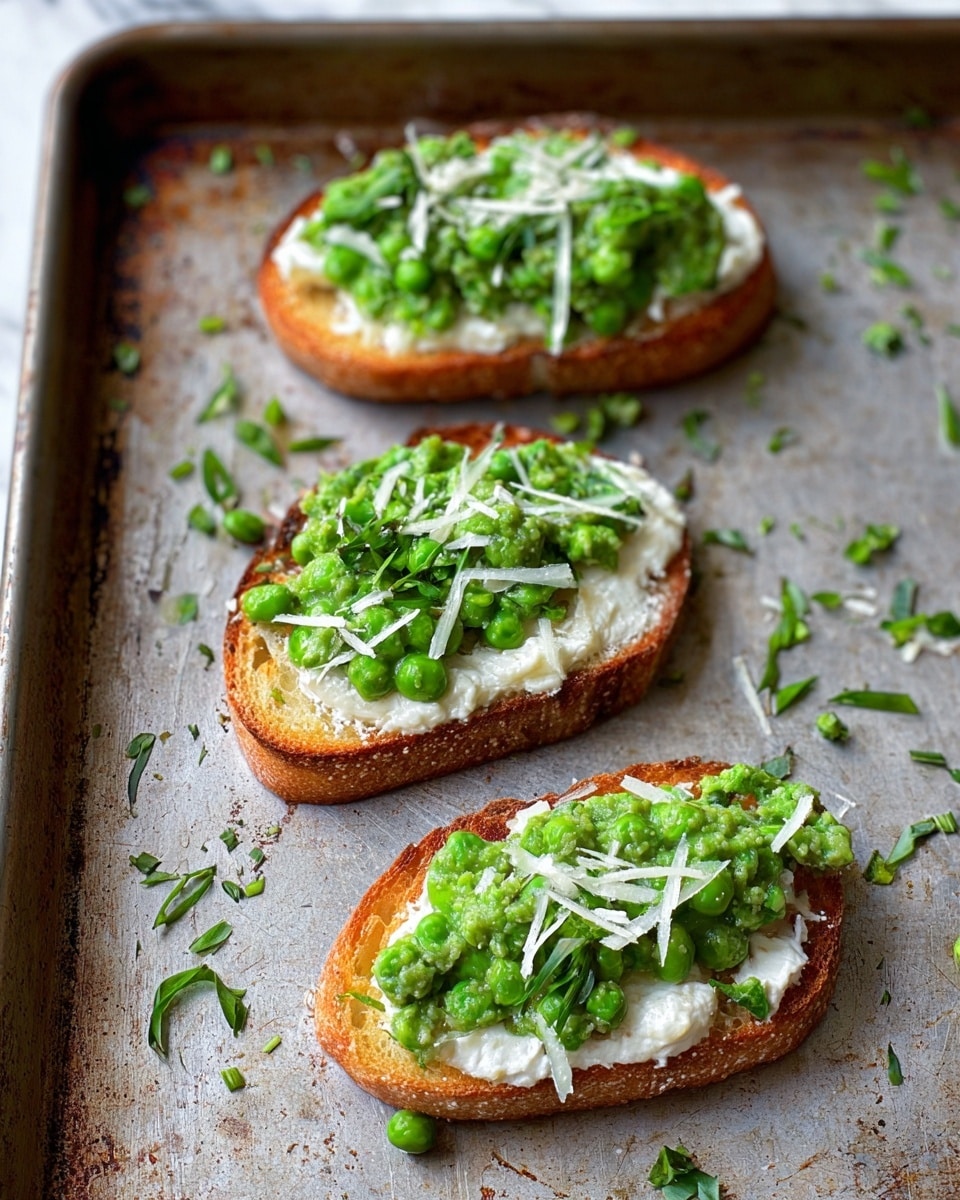 Three slices of toasted bread lay on a worn metal baking tray with a white marbled texture background. Each slice has a bottom layer of golden-brown toasted bread, topped with a thick layer of white creamy cheese. On top of that, there is a bright green layer of mashed peas mixed with chopped fresh herbs. Finally, thin white shreds of cheese and small green herb leaves are scattered over the top and around the tray for extra texture. photo taken with an iphone --ar 4:5 --v 7