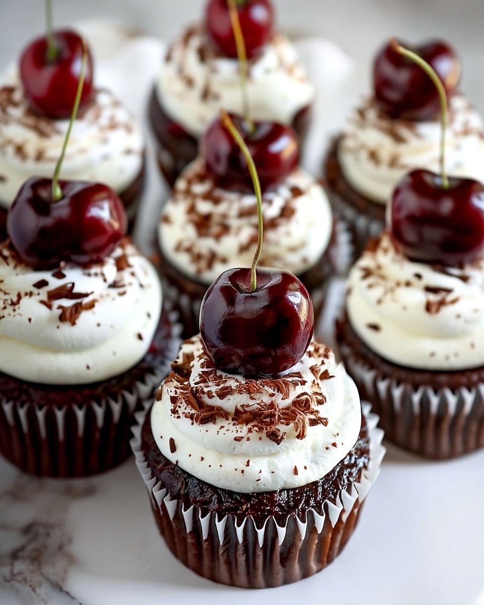 The image shows several chocolate cupcakes arranged closely together on a white marbled surface. Each cupcake has three clear layers: the base is a dark brown, moist chocolate cake in a white cupcake liner; on top of the cake is a thick swirl of white whipped cream frosting with a soft, smooth texture; the frosting is sprinkled with small, thin shavings of chocolate in a dark brown color, adding texture and contrast. A shiny, deep red cherry with a green stem sits on the very top of each cupcake, centered perfectly on the whipped cream. The photo is taken with an iphone --ar 4:5 --v 7