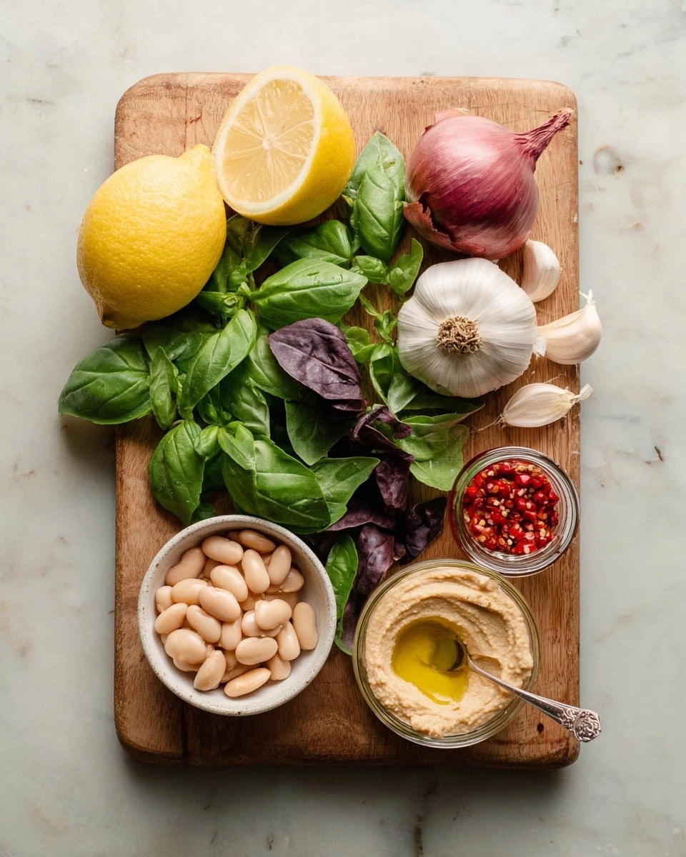 The image shows a wooden cutting board placed on a white marbled surface. On the board, at the top left corner, there is a halved lemon with a bright yellow rind and juicy pale interior next to a whole lemon. Beside them to the right, there is a shallot with smooth purple skin and a garlic bulb with white papery skin and one peeled clove. The center of the board is filled with fresh green leaves of basil and some darker purple leaves mixed in. In the bottom left corner, there is a small round white bowl filled with pale beige white beans. Next to it on the right, there is a clear jar containing red chili peppers with seeds visible inside and a spoon resting in it. Finally, to the right of the chili jar, there is another small white bowl with smooth, creamy beige hummus drizzled with olive oil on top. Photo taken with an iphone --ar 4:5 --v 7