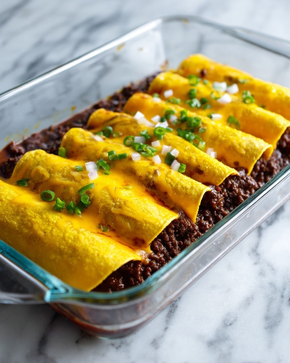 The image shows a close-up view of a glass baking dish filled with layered enchiladas. The bottom layer consists of dark brown cooked ground meat spread evenly inside the dish. On top, folded yellow tortillas are placed side by side along the dish’s length. Melted yellow cheddar cheese is spread over the tortillas, with small white chopped onions sprinkled on top. The dish is placed on a white marbled surface. The texture of the meat looks moist but firm, and the cheese is smooth and melted, covering parts of the tortillas and meat. Photo taken with an iphone --ar 4:5 --v 7